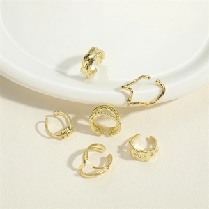 Adjustable 6-piece gold ear cuff set with woven wave and star designs on white ceramic