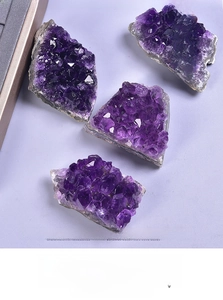 Detailed view of four natural Uruguayan amethyst crystal clusters with deep purple points