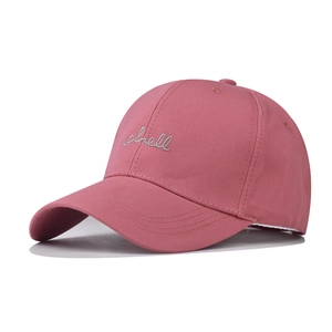 Close-up of shell embroidery detail on pink washed cotton baseball cap texture