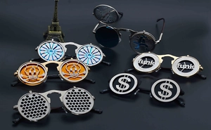 Detail view of steampunk flip-up sunglasses with funk letters and metallic skull patterns
