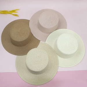Flat top straw sun hats in brown, pink, and beige with subtle shimmer details