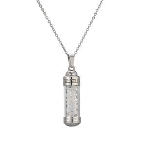 Detailed view of perfume bottle pendant with silver Greek key pattern and clear crystals