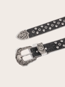 Detail of black glitter belt with silver engraved metal buckle and rhinestone studs
