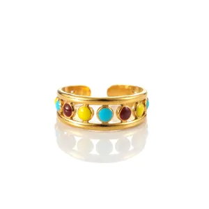 Detail of adjustable gold-plated stainless steel ring with colorful enamel inlay accents