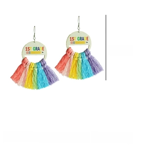 Detail of 1st Grade rainbow fringe earrings with wooden discs and colorful cotton tassels