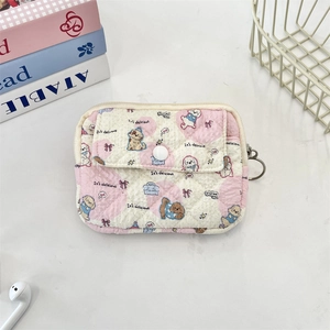 Detail of pink quilted card holder with cute dog patterns and metal key ring accessory