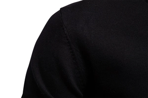 Detailed view of the shoulder stitching and knit texture of a black V-neck cotton sweater