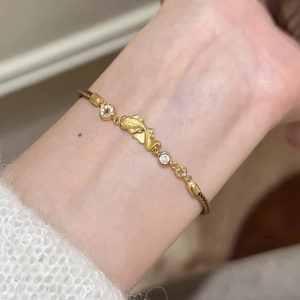 Elegant gold plated koi fish bracelet with sparkling zircons and ancient coin elements