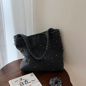 Borsa tote grigio scuro in tessuto a macchie colorate su tavolo in legno, minimalista