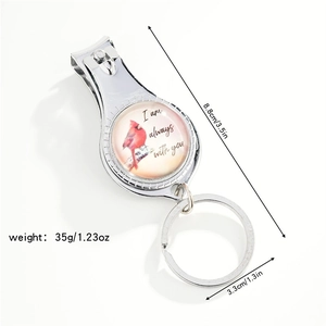 Detailed view of metal nail clipper keychain with dimensions and red bird design
