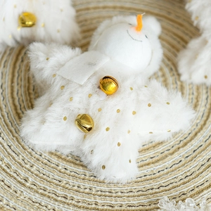 Star-shaped snowman Christmas plush pendant with gold bell on beige woven mat