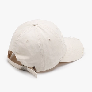Cream white washed cotton baseball cap with distressed details and adjustable metal buckle