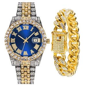 Close-up of hip-hop watch set with iced-out Cuban bracelet and blue Roman numeral dial