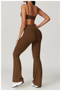 Detail view of the deep brown backless sports bra with sleek cross straps and matching leggings