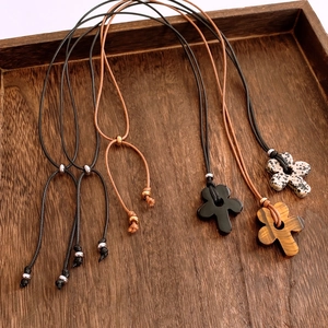 Macro view of flower-shaped tiger eye stone pendants with adjustable braided cords
