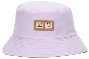 Detail of light purple bucket hat featuring a leather patch with a wink smiley face logo