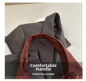 Detail of soft brown suede strap and high-quality texture on a large shoulder tote bag