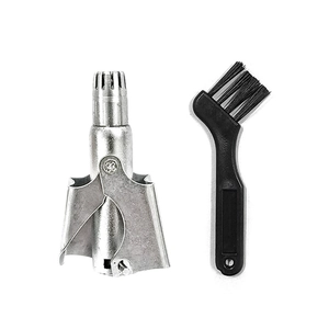 Manual stainless steel nose hair trimmer with cleaning brush on a white background