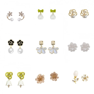 Elegant floral earring collection featuring pearl studs, rose charms, and tulip hooks