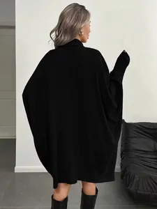 Rear view of black long-sleeved oversized knit sweater featuring vertical ribbed texture