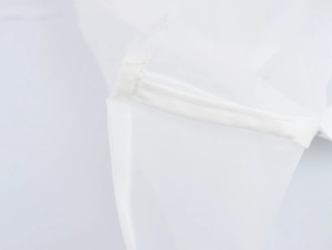 Close-up of white organza fabric showing intricate texture and reinforced seam details