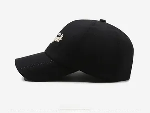 Detail view of black baseball cap showing breathable eyelets and 3D white embroidery