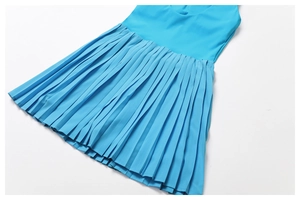 Detailed view of light blue tennis dress featuring fine pleated hem and smooth fabric