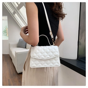 Rear view of model wearing white quilted chain bag with gold hardware and PU leather strap