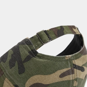 Detailed close-up of the adjustable metal buckle and camouflage fabric on the baseball cap