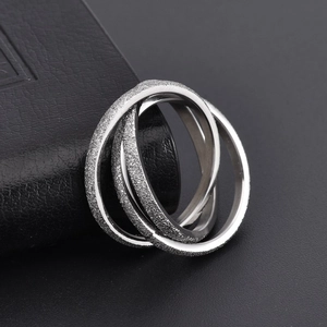 Macro shot of interlocking triple ring design featuring frosted and polished steel finish