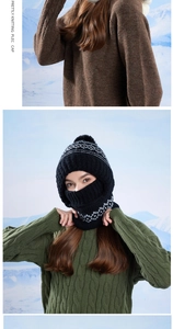 Detail of a thick knit balaclava with grey Nordic patterns and a black pompom on top