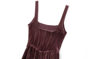 Detailed view of dark purple velvet dress with square neckline and waist seam texture