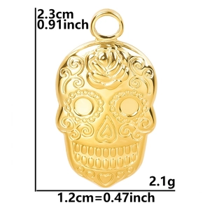 Gold skull pendant with rose engraving detail measuring 2.3cm by 1.2cm height and width