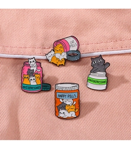 Detailed macro view of colorful cat-themed enamel pins on a textured pink fabric surface