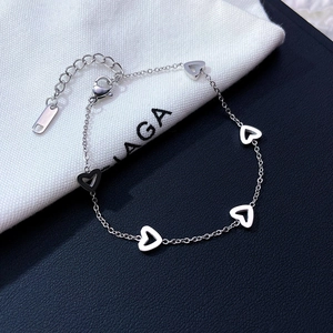 Silver stainless steel heart charm bracelet featuring five hollow heart-shaped elements