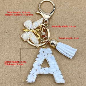 Detailed size specifications of white resin letter A keychain with gold butterfly