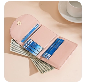 Detail view of pink tri-fold PU leather wallet interior with multiple card slots