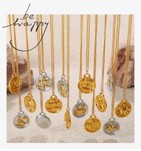 Detailed close-up of French vintage 18K gold zodiac relief pendants on fine chain necklaces