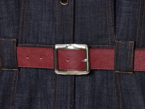 Detail of dark blue denim dress with wine red belt and silver square metal buckle