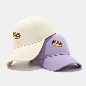Fashion baseball caps in beige and lavender with hot dog embroidery on a clean background