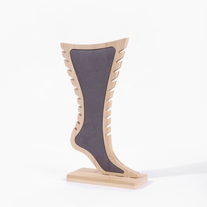 Detail of bamboo jewelry stand with grey flocking liner and side slots for necklaces
