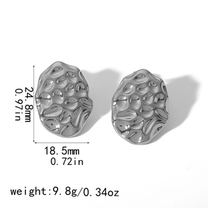 Detail showing dimensions and silver hammered texture of oval titanium steel earrings