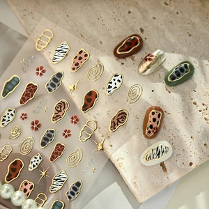 French animal print nail art stickers with leopard zebra patterns and gold foil accents