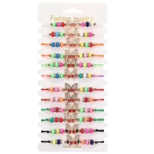 Set of 12 colorful braided bracelets with crystal butterfly charms on display card