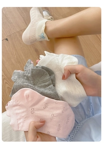 Detail shot of breathable cotton ankle socks featuring sweet bow embroidery and lace textures