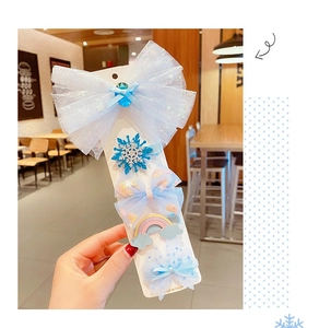 Detailed set of blue Frozen-themed hair clips with mesh bows and sequin snowflake on card