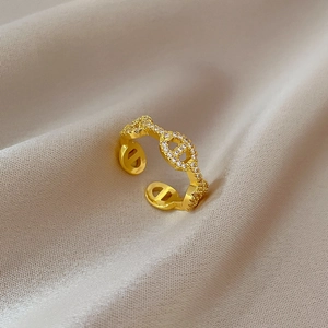 Detail of gold pig nose open ring featuring micro-pave cubic zirconia on satin