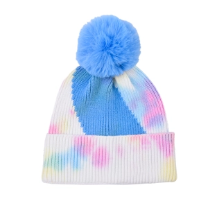 Tie-dye knit beanie for women with large blue faux fur pompom for winter outdoor warmth