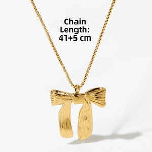 Detail of golden bow pendant necklace with textured surface and 41+5cm chain length
