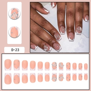 French tip press-on nails with 3D butterfly accents and silver rhinestones on nude base